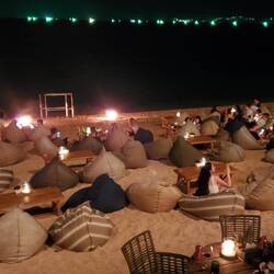 The bean bag chairs on the beach in front of the restaurant!