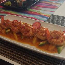 Yummy prawns in a delicious sauce on a bed of mango and avo