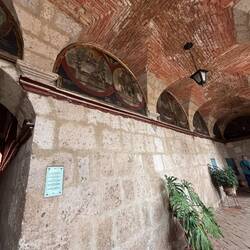 There are 55 paintings around the room, just like a rosary