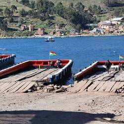 The open barges that vehicles are loaded into for the crossing.