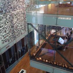 A family using the screen to search for individuals details on the wall