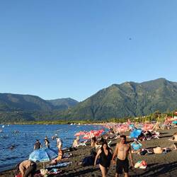 Crazy summer people-fest; Pucon beach, Villarrica Lake