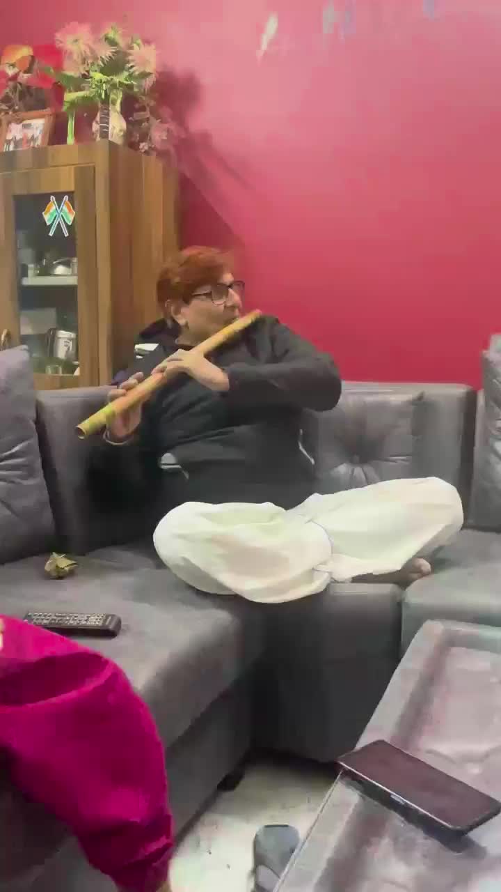 Vishy's father playing the flute
