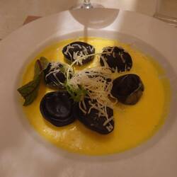 Ravioli made with black squid ink filled with crab