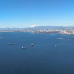JL38 descending over Tokyo Bay with Mount Fuji in the background.