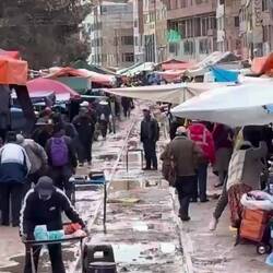 The train goes right down a street and the vendors waste no time getting back to business