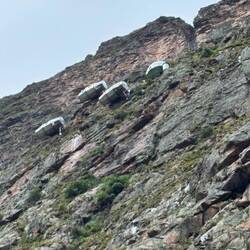 These capsules on the side of the mountain are hotel rooms for mountain climbers