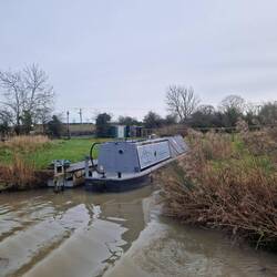 Cute little boat in its own arm dug into the field