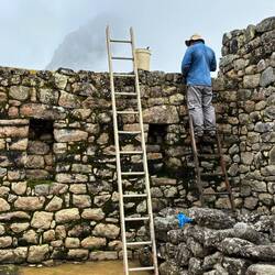You can see workers all over the site, removing lichen