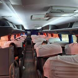 Semi sleeper double deck bus, wide comfy seats that recline about 45 degrees and have leg rests too.