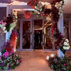 Spectacular wedding flowers at entrance to outside dinner
