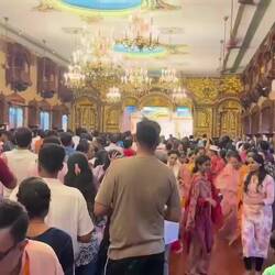 Hare Krishna singing and dancing; men on the left, women on the right