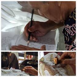 Drawing the pattern and the placing wax over the drawing on both sides of the cotton/silk.