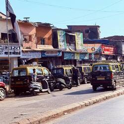 One of the larger streets in the slum, with bustling traffic