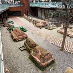 The Roman necropolis in Plaça Vila de Madrid (2nd-3rd century CE) features ancient coffins outdoors.