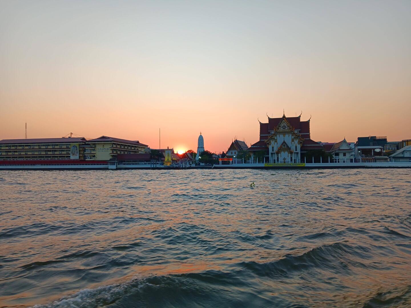 River bus view of Wat Arun at sunset