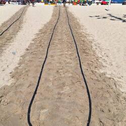The sand is so hot they need to cool it to walk on.