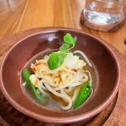 Noodles in crab shell yuzu kosho broth and peas
