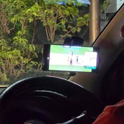 Uber driver watching cricket (whilst driving)