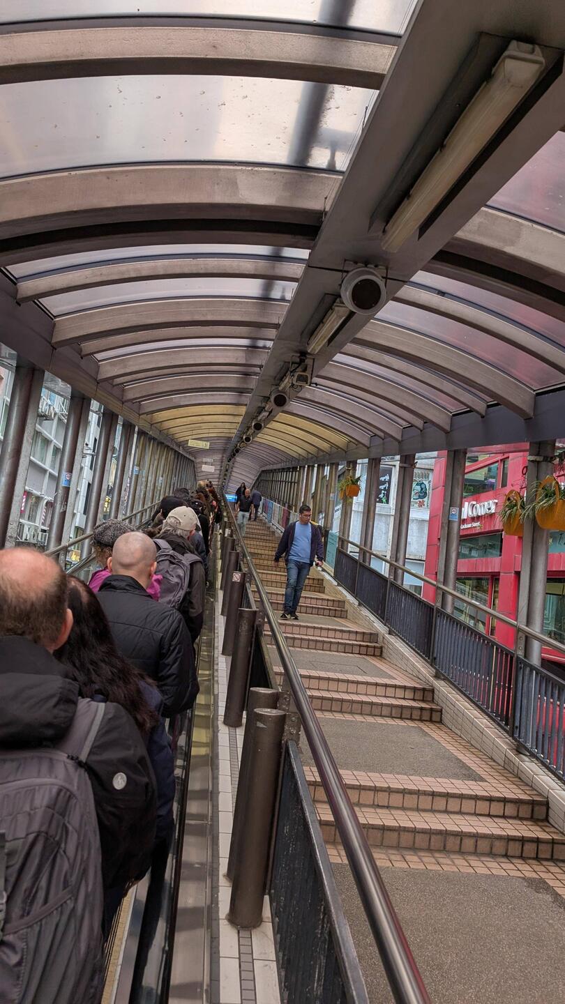 The massive escalator goes down hill in the morning and up hill after peak hour finishes