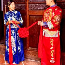 Wedding couple wears traditional robes