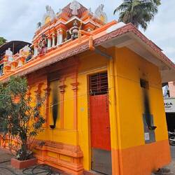 A small temple smack in the middle of the street.