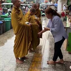 'Buying' a blessing for her and her shop (?).