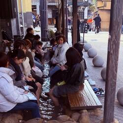 Alongside a street at Arimo Onsen, people soak their feet in a 104 degree hot spring