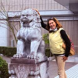 Rubbing the lion's back and tail for good luck