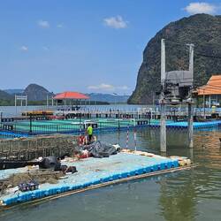 Floating soccer field. Fish traps in the foreground.