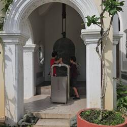 The boys ringing a temple bell.