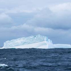 A nearby iceberg tempers our disappointment in Visokoi hiding itself from our eyes.