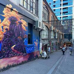 Artist working on an a model ak47 fastened to the wall