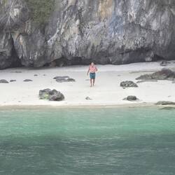 He swam to a small beach.