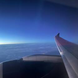 Flying over Japan. You can sea city lights just above the engine.