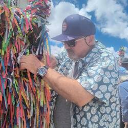 Tying ribbon to fence