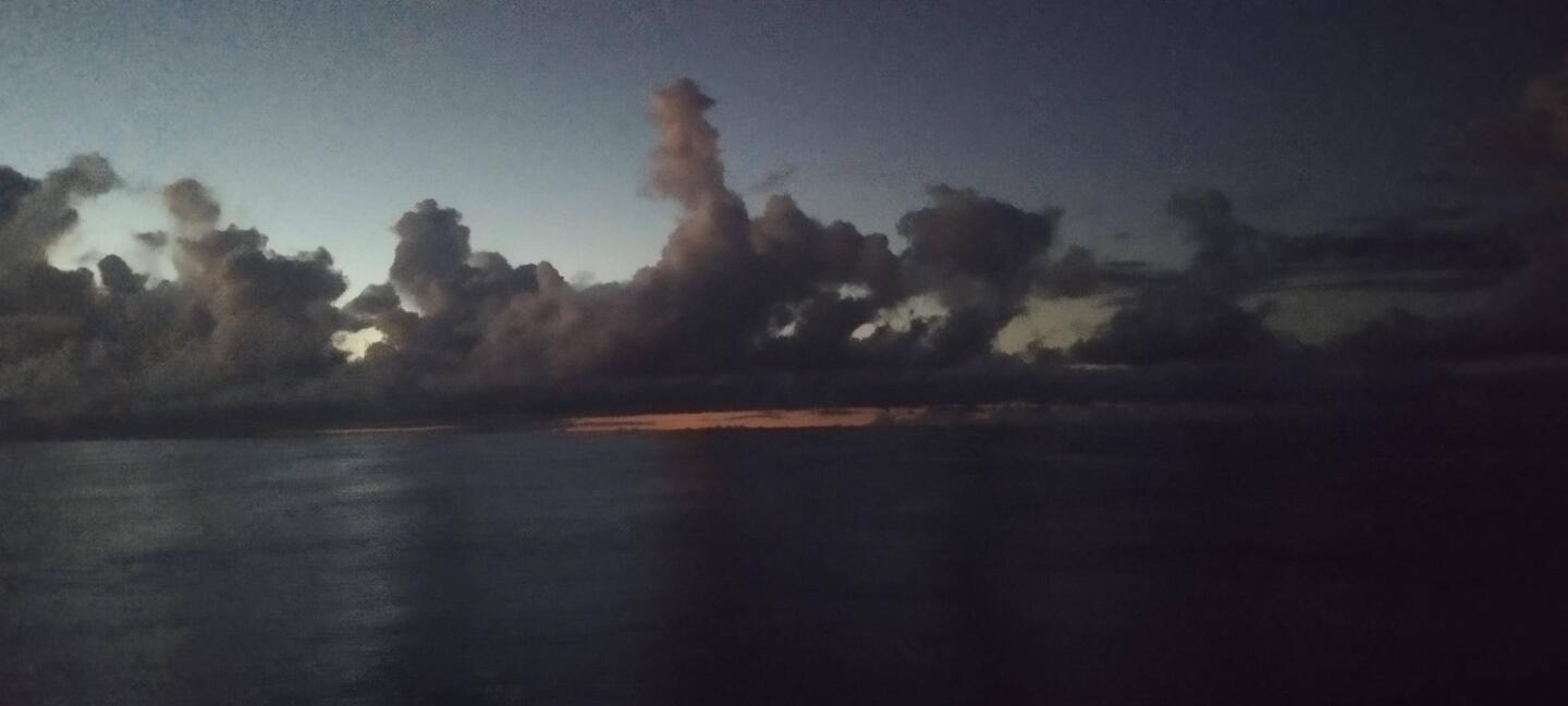 Sun about to rise over a calm sea
