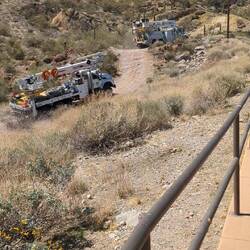 They were doing line work. 2nd truck got stuck! Very steep and rough.