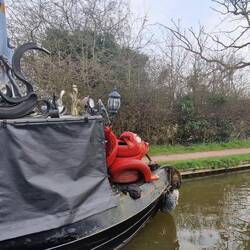 A tyre dragon on the front of this boat and some sort of cobra on top?