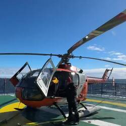 Not so easy to get out of a small helicopter with all the gear we are wearing!