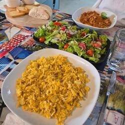 Bread, olives, fish dip, potato soup, salad, bacala and rice and bolognese