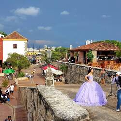 A bride-to-be takes staged but certainly inauthentic photos of herself in front of the Naval Museum.
