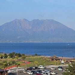 Sakurajima from the ship in the late afternoon. A bit of smoke is coming from the top.