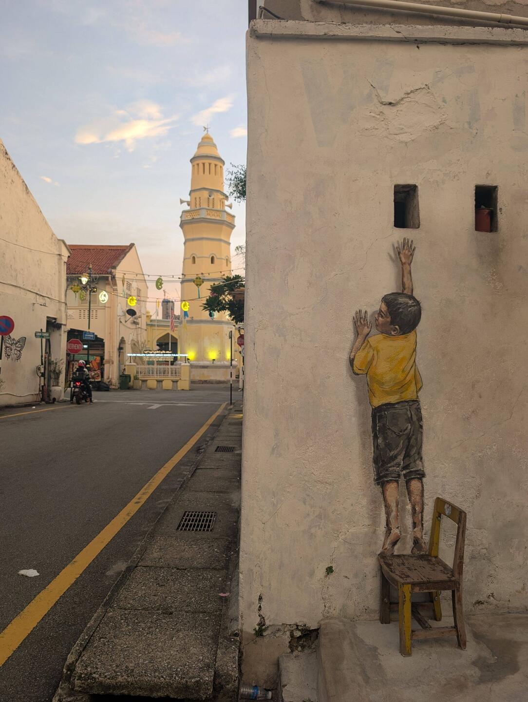Boy on Chair by Ernest Zacharevic