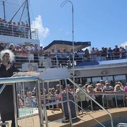 The 'judge' is on the left; but the Captain's staff (under shelter) are the actual judge & jury.