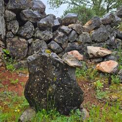 The smaller rock on top is balancing