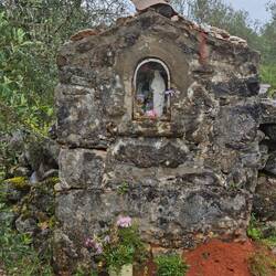 A shrine to the Virgin Mary built beside a path in the middle of nowhere. Note the offerings