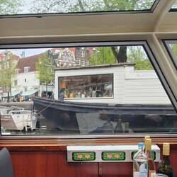 On the canal sailing by someone's little house on the water