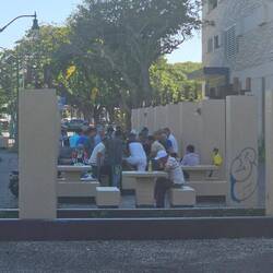 Men playing various card games along the river.