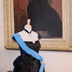It's fun to see the original dress from the portrait on display in front of it.